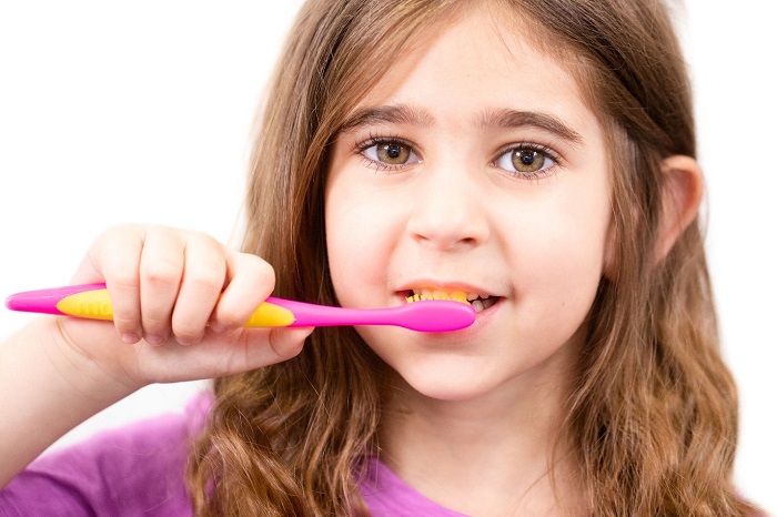 girl with toothbrush